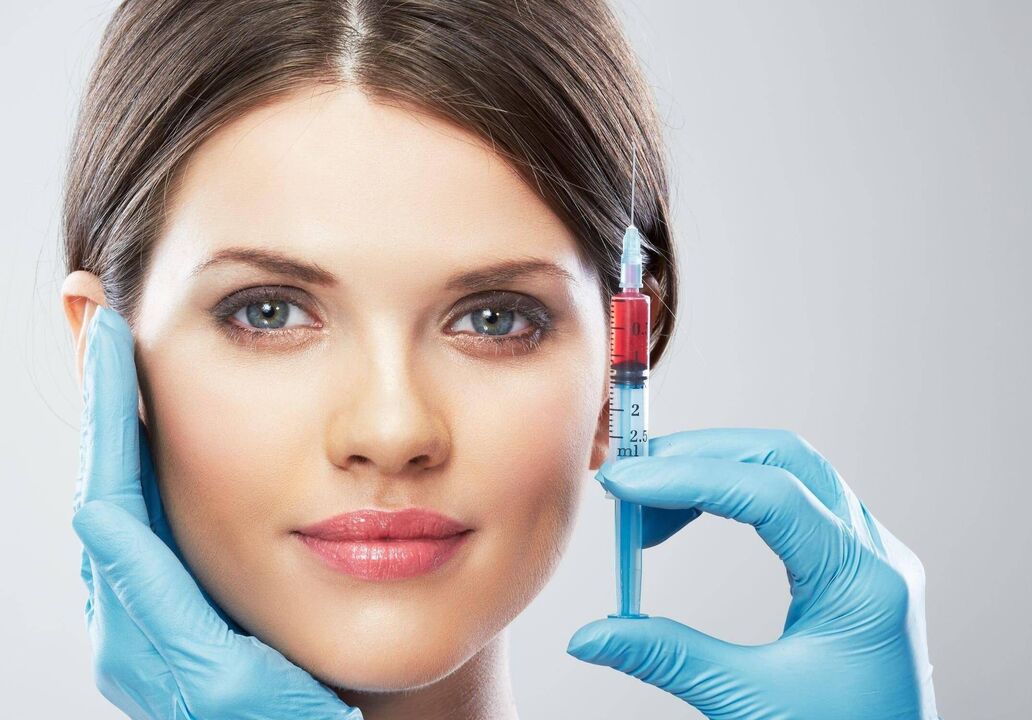 syringe with plasma to renew facial skin