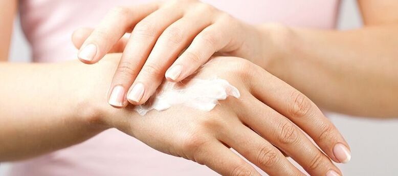 applying cream on the skin of the hand